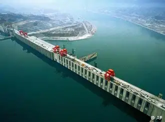 This Xinhua file photo taken in December 2004 shows the aerial view of the Three Gorges Dam in Yichang, central China's Hubei Province. The axis of the dam is 2,309 meters, the longest in the world. The construction crews expect to finish pouring concrete for the massive Three Gorges Dam on Saturday, completing what China calls the world's largest concrete structure, state media reported Friday, May 19, 2006. (AP Photo / Xinhua, Du Huaju)
