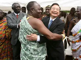 In this photo released by China's Xinhua News Agency, visiting Chinese Premier Wen Jiabao , center right, embraces a local chief during his visit in Accra, capital of Ghana, Monday, June 19, 2006. Wen's tour of seven African nations already had brought him to Egypt and Ghana and will also take him to Angola, South Africa, Tanzania and Uganda. Ghana's President John Kufuor is seen at second left. (AP Photo/Xinhua, Li Xueren)
