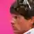 A profile view of German cyclist, Jan Ullrich with the T Mobile logo unfocused in the background