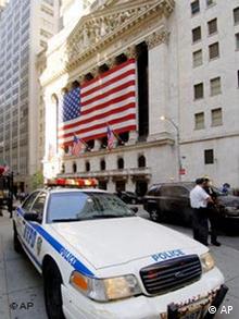 A New York City Police Department squad car sits on the sidewalk in front of the New York Stock Exchange