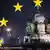 A montage with the Kremlin and central Moscow in the background, with the yellow stars of the EU flag over the top.
