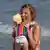 Mother holding her child at the beach