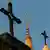 An Islamic symbol between crosses on top of a church and minaret