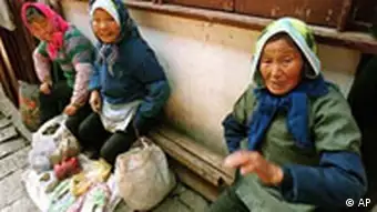 Three women sell products from their farms, including medicinal herbs, on a side street side in the outskirts of Shanghai, China Friday June 11, 1999. (AP Photo/Eugene Hoshiko)