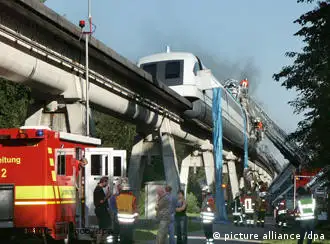 Emergency workers try to gain access to the crushed Transrapid train