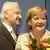 Edmund Stoiber and Angela Merkel, holding a bouqet of flowers