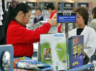 FILE ** A Chinese cashier rings up products being purchased by a Chinese customer in one of the Chinese outlets of the American supermarket Wal-Mart in Beijing, China, in this Oct. 12, 2006, file photo. Wal-Mart Stores Inc. is bidding about $1 billion (euro800 million) for a chain of 100 hypermarkets in China in a deal that could vault it ahead of competitors to become the country's biggest food and department store network. (AP Photo/Elizabeth Dalziel/File)