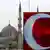 The white crescent of the Turkish flag is seen in front of the New Mosque in Istanbul, Turkey