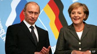German Chancellor Angela Merkel, right, and Russian President Vladimir Putin stand together during a signing ceremony of economic contracts at the German-Russian summit in Tomsk in 2006