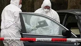 Investigators of the Federal Agency for Radiation Protection examine a BMW car on an estate in Haselau, west of Hamburg, northern Germany, Monday Dec. 11, 2006. Traces of radiation found at sites in Germany linked to a contact of poisoned former Russian spy Alexander Litvinenko likely are the rare radioactive substance polonium-210, authorities said Sunday. Police said that traces of alpha radiation had been found at the homes in Hamburg and in Haselau of the ex-wife and the former mother-in-law of Dmitry Kovtun. (AP Photo/Fabian Bimmer)