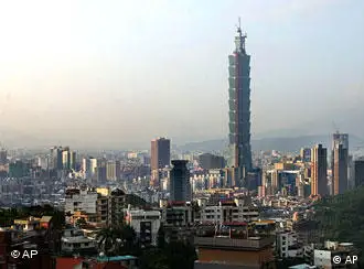 Taipei 101, the world's tallest skyscraper standing at 1,676-foot-tall, is seen from the fringes of Taipei, Thursday, Nov. 13, 2003. The main shopping mall in the lower levels of the building will be open to the public which is expecting a record turnout. The building is approximately 165 feet taller than the world's former highest office building, the Petronas Towers in Kuala Lumpur, Malaysia. The highest freestanding tower remains the CN Tower, a 1,815-foot communications structure and outlook point in Toronto. (AP Photo/Wally Santana)