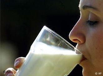 A woman drinking milk from a glass