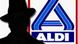 Silhouette of a man in front of Aldi supermarket logo Silhouette of a man in front of Aldi supermarket logo