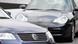 A VW Passat parked next to a Porsche A VW Passat parked next to a Porsche