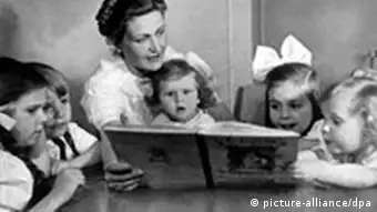 Magda Goebbels reads a book to her five children