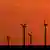 Windmills against an orange sky
