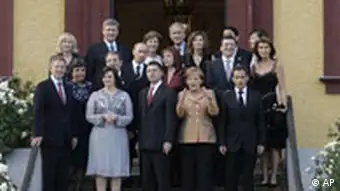 German Chancellor Angela Merkel, front row, stands with other G8 leaders and their spouses