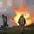 Украинский пожарный на фоне горящих цистерн с фосфором