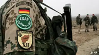 Patches of the German flag and ISAF emblem are visible on a German soldier's upper arm