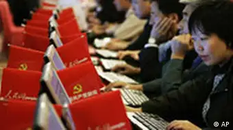 Delegates surf the People's Website on Chinese Communist Party News during the 17th Communist Party Congress held at the Great Hall of the People in Beijing, Monday, Oct. 15, 2007. Chinese leader Hu Jintao pledged Monday to make the communist government more open and responsive while moderating the juggernaut economy to produce more balanced growth.(AP Photo/Andy Wong)