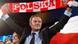 Donald Tusk holding a red and white Polska scarf Donald Tusk holding a red and white Polska scarf