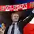 Donald Tusk holding a red and white Polska scarf