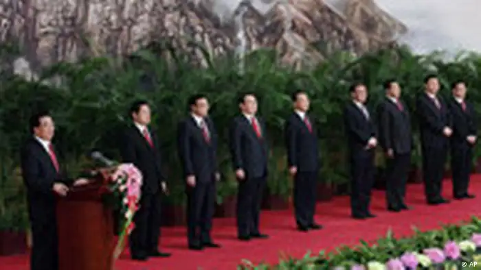 Chinese President Hu Jintao, left, delivers his speech and introduces the new members of the Politburo Standing Committee, from left, Public Security Minister Zhou Yongkang, Liaoning Party Secretary Li Keqiang, head of Communist Party Ideology Department Li Changchun, Premier Wen Jiabao, National People's Congress Chairman Wu Bangguo, Chairman of the Chinese People's Political Consultative Conference Jia Qinglin, Shanghai Party Secretary Xi Jinping, and He Guoqiang, the head of the Communist Party Organization Department at the Great Hall of the People in Beijing, China, Monday, Oct. 22, 2007. The Standing Committee, the inner circle of Chinese political power, was paraded in front of assembled media on the first day following the end of the 17th Communist Party Congress. (AP Photo/Andy Wong)