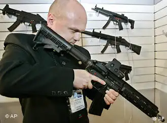 Police officer Piotr Brykalski from Poland looks at the new HK416 enhanced carbine designed by German firm Heckler and Koch at the 14th Paris Milipol 2005, the worldwide exhibition of internal state security, at Le Bourget , north of Paris, Tuesday Nov. 22, 2005. (AP Photo/Francois Mori)