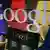 Google logo on a chair against a big google logo backdrop