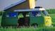 A green VW Bulli bus stands on a meadow A green VW Bulli bus stands on a meadow