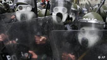 Riot police officers advance toward anti-government protesters on Wednesday Nov. 7, 2007