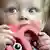 Baby chewing on teething-toy
