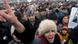A woman raises her hand during a protest A woman raises her hand during a protest