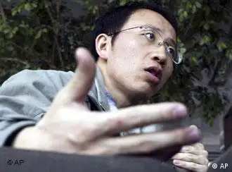 **FILE** Outspoken Chinese AIDS activist Hu Jia gestures during an interview at a cafe in Beijing, in this March 31, 2006 file photo. Hu was charged with subverting China's government after security officers barged into his home and took him away, a watchdog group and lawyer said Saturday, Dec. 29, 2007. (AP Photo/Ng Han Guan, File)