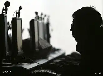 A computer user is silhouetted with a row of computer monitors at an Internet cafe in Shenyang, northern China's Liaoning province Wednesday Jan. 23, 2008. China shut down 44,000 Web sites and arrested 868 people for Internet pornography last year, state media said Wednesday. (AP Photo) ** CHINA OUT **