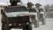German personnel carriers in a line on an Afghan road German personnel carriers in a line on an Afghan road