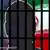 A graphic silhouette of a man and jail bars in front of the Iranian flag