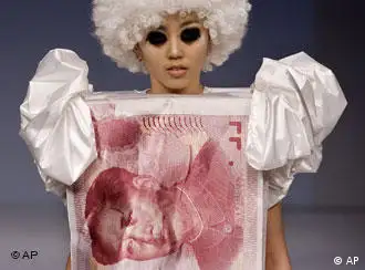 **FILE **A model parades in a Bandi Panda creation in the shape of a Chinese one hundred yuan note, by designer Zhao Bandi, during the China Fashion Week in Beijing in this Nov. 4, 2007 file photo. Dominique Strauss-Kahn, the managing director of the International Monetary Fund said Friday, Feb. 15, 2008 he is urging Chinese leaders to ease exchange rate controls to address global financial imbalances and their own economic challenges. (AP Photo/Andy Wong, File)