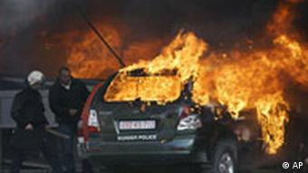 Burning vehicle after clashes in Kosovo