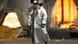 A worker walks in front of a furnace at a steel factory A worker walks in front of a furnace at a steel factory