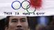 Chinese demonstrator with bloodstained banner of Olympic logo saying "This is not a game" Chinese demonstrator with bloodstained banner of Olympic logo saying "This is not a game"