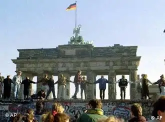 89年的11月9日，前东德的边防士兵只能看着人们在柏林墙上欢呼雀跃。