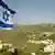 Israeli flag over West Bank countryside