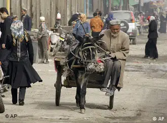An Uighur ethnic minority man rides a donkey cart at the grand bazaar in Hotan, northwest China's Xinjiang Uighur Autonomous Region on Saturday, April 5, 2008. Chinese authorities are blaming a radical Islamic group for instigating recent protests in the restive western region of Xinjiang, state media reported. (AP Photo/Eugene Hoshiko)