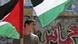 A youth holds a Palestinian flag A youth holds a Palestinian flag