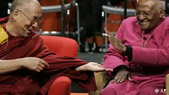 The Dalai Lama, left, slaps palms with Archbishop Desmond Tutu, of South Africa, during one of many lighthearted moments as they speak at a panel discussion addressing the topic of inspiring spiritual compassion in youth Tuesday, April 15, 2008 at the University of Washington in Seattle. (AP Photo/Ted S. Warren)