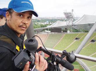 Video journalist with a camera in a stadium