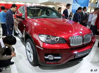 Visitors look at a BMW X6 at the Auto China 2008 auto show in Beijing Tuesday, April 22, 2008. Auto sales in China are booming, with analysts and automakers forecasting growth at 15-20 percent this year. (AP Photo/Greg Baker)