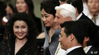From left, China Philarmonic Orchestra Soprano Lan Rao, Mezzosoprano Zheng Cao, Conductor long Yu, partially hidden by Pope Benedict XVI, in white, pose for a photo with other members of the orchestra, during a concert in Pope Paul VI hall at the Vatican, Wednesday, May 7, 2008. The China Philharmonic Orchestra performed for the pontiff in a landmark concert Wednesday that could indicate warming relations between Beijing and the Vatican. Benedict called it a truly unique event and offered a thank you in Chinese at the end of the hour-long concert. (AP Photo/Plinio Lepri)