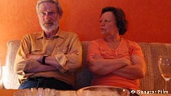 A couple sits on the couch in a scene from Andreas Dresen's film Wolke 9